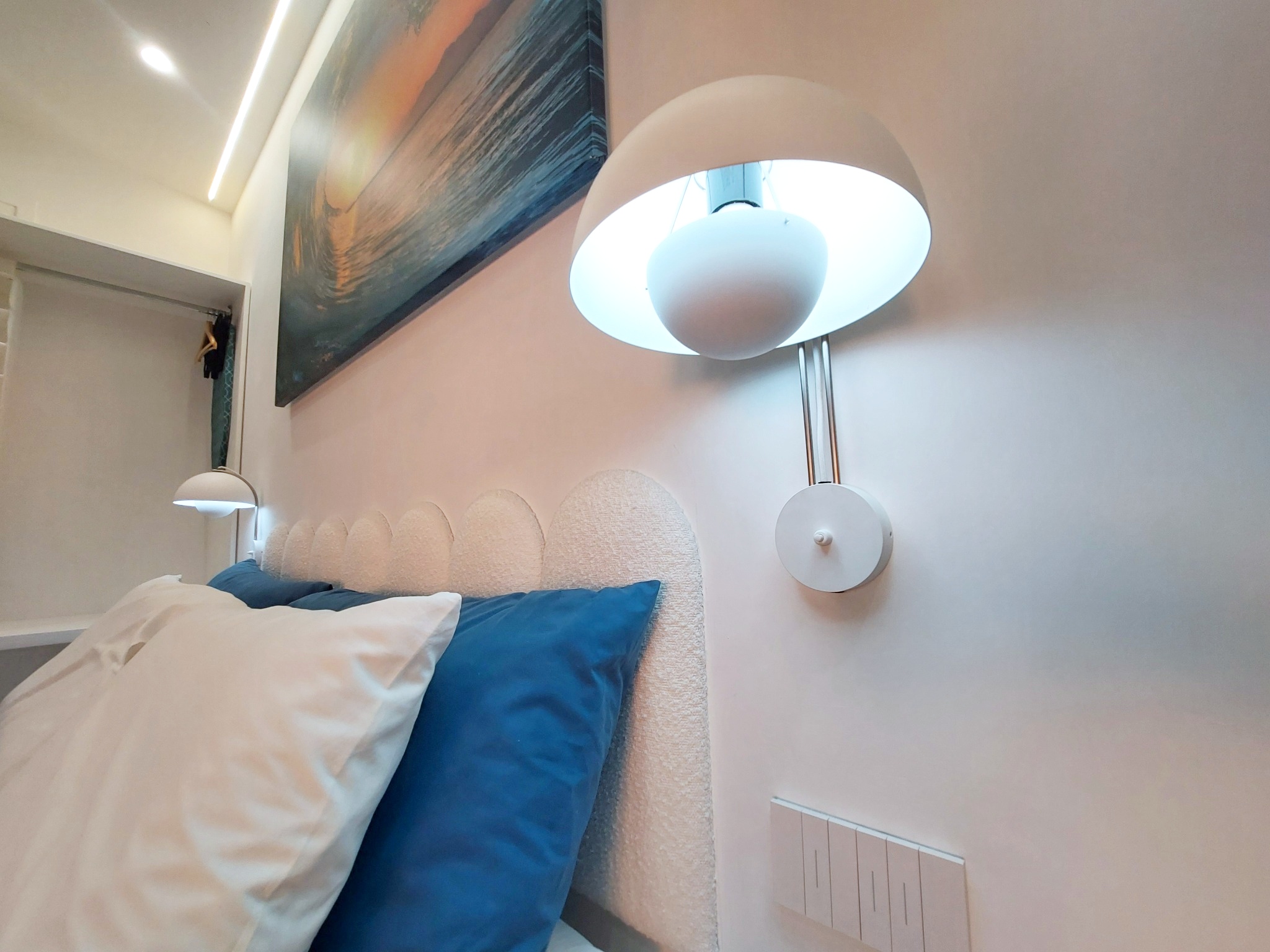 Wall lamp and blue pillows