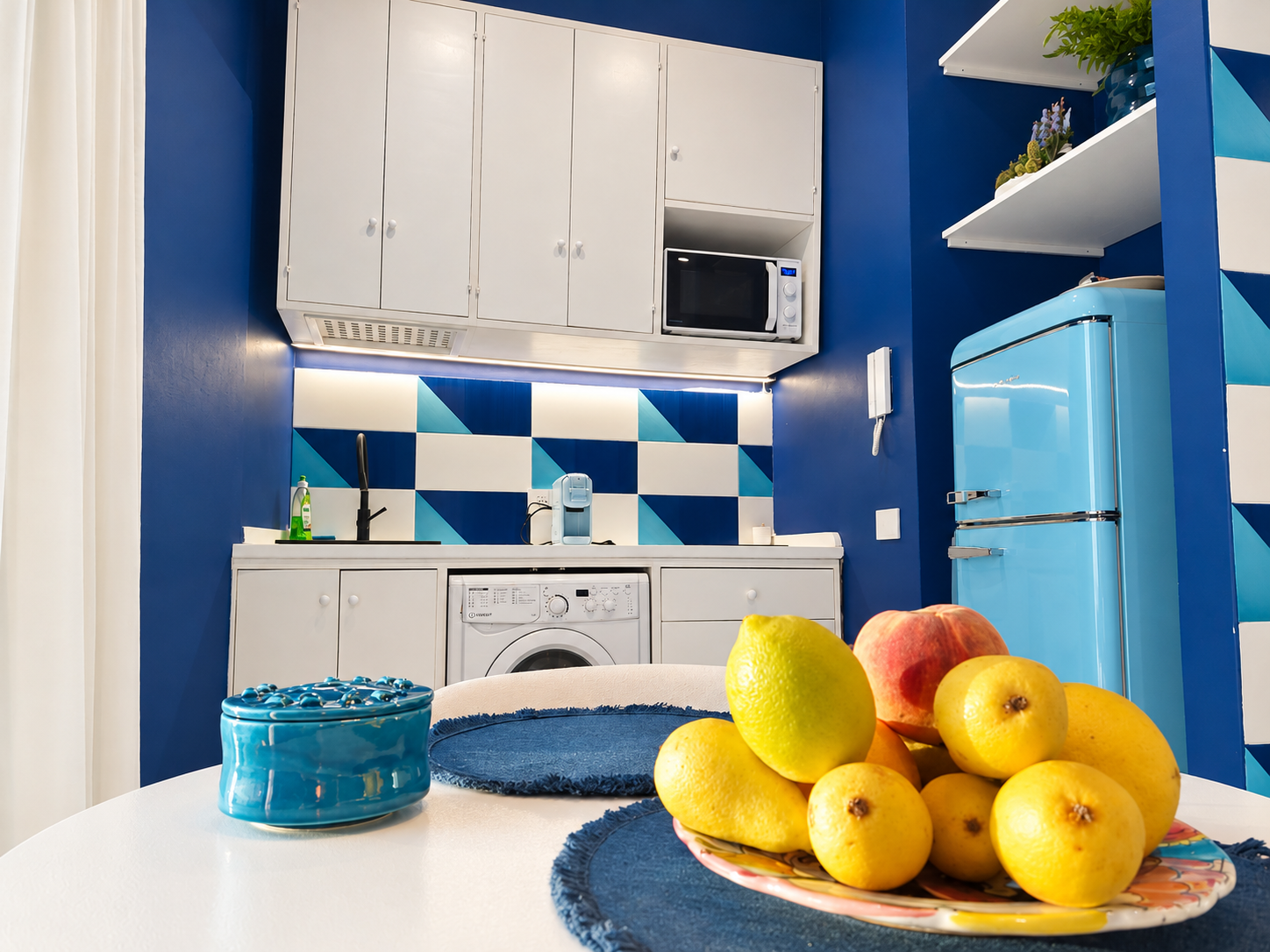 Modern kitchen with blue fridge and lemons