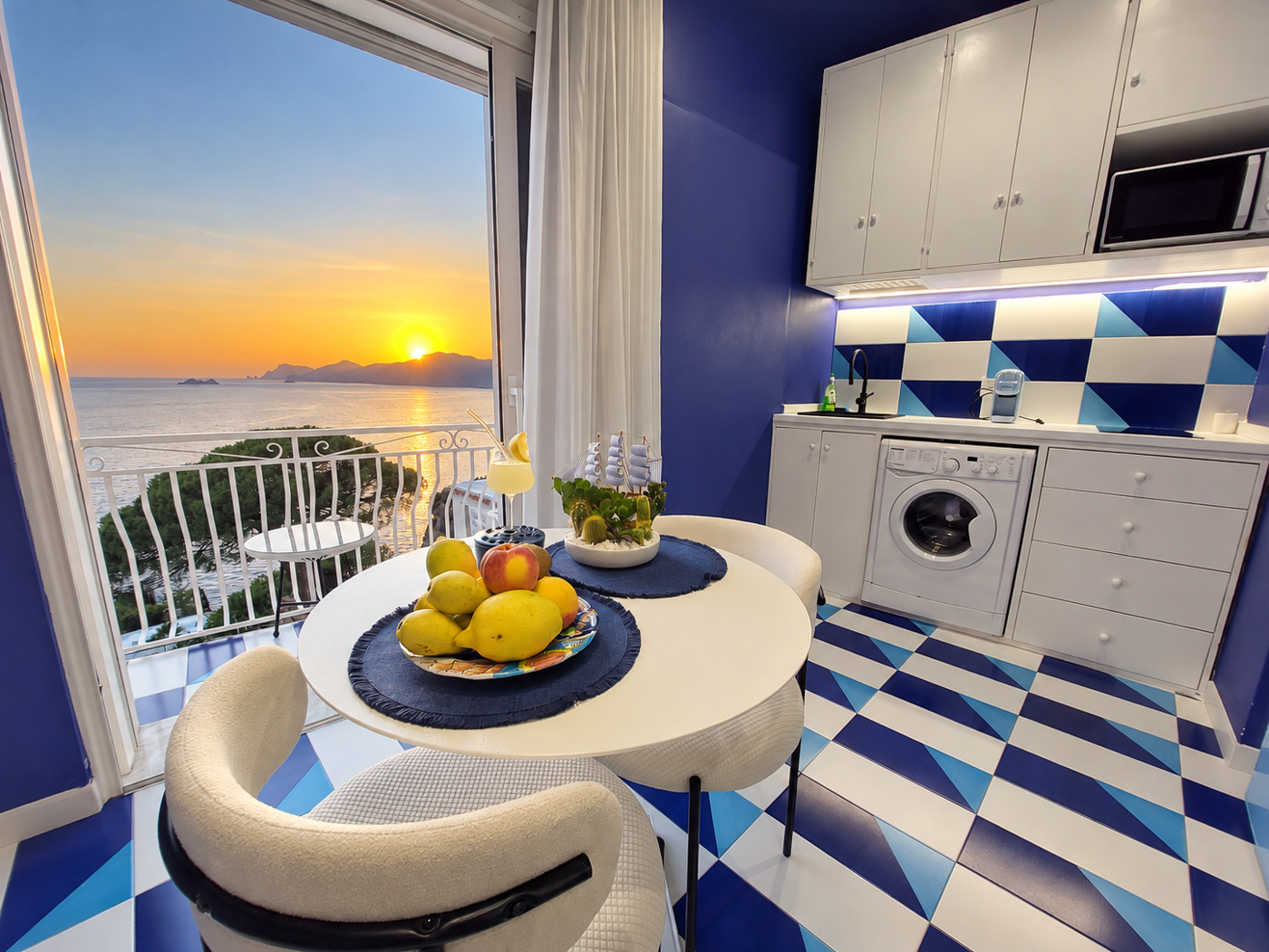 Modern kitchen with sea view at sunset