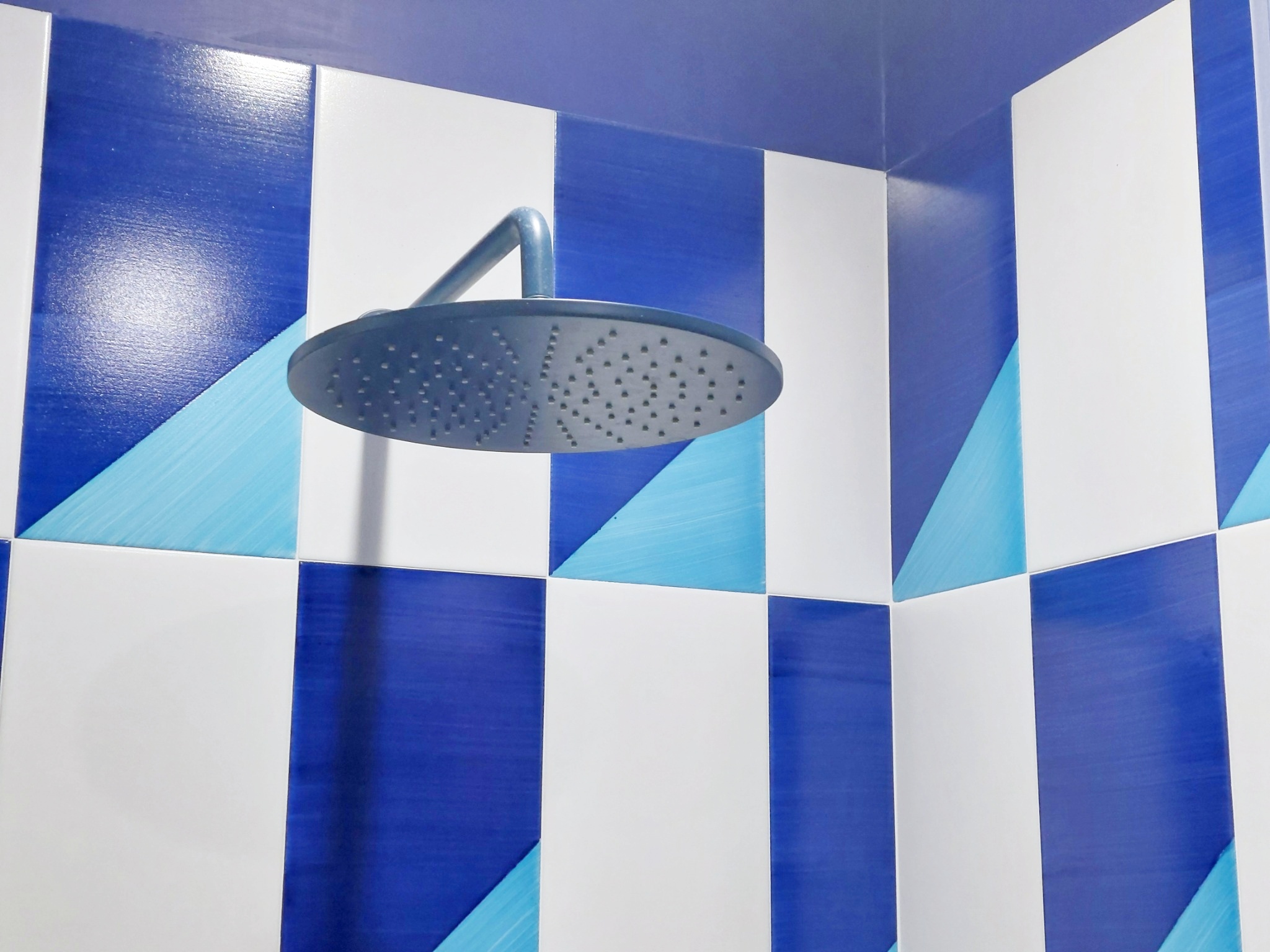 Rain shower with geometric blue tiles